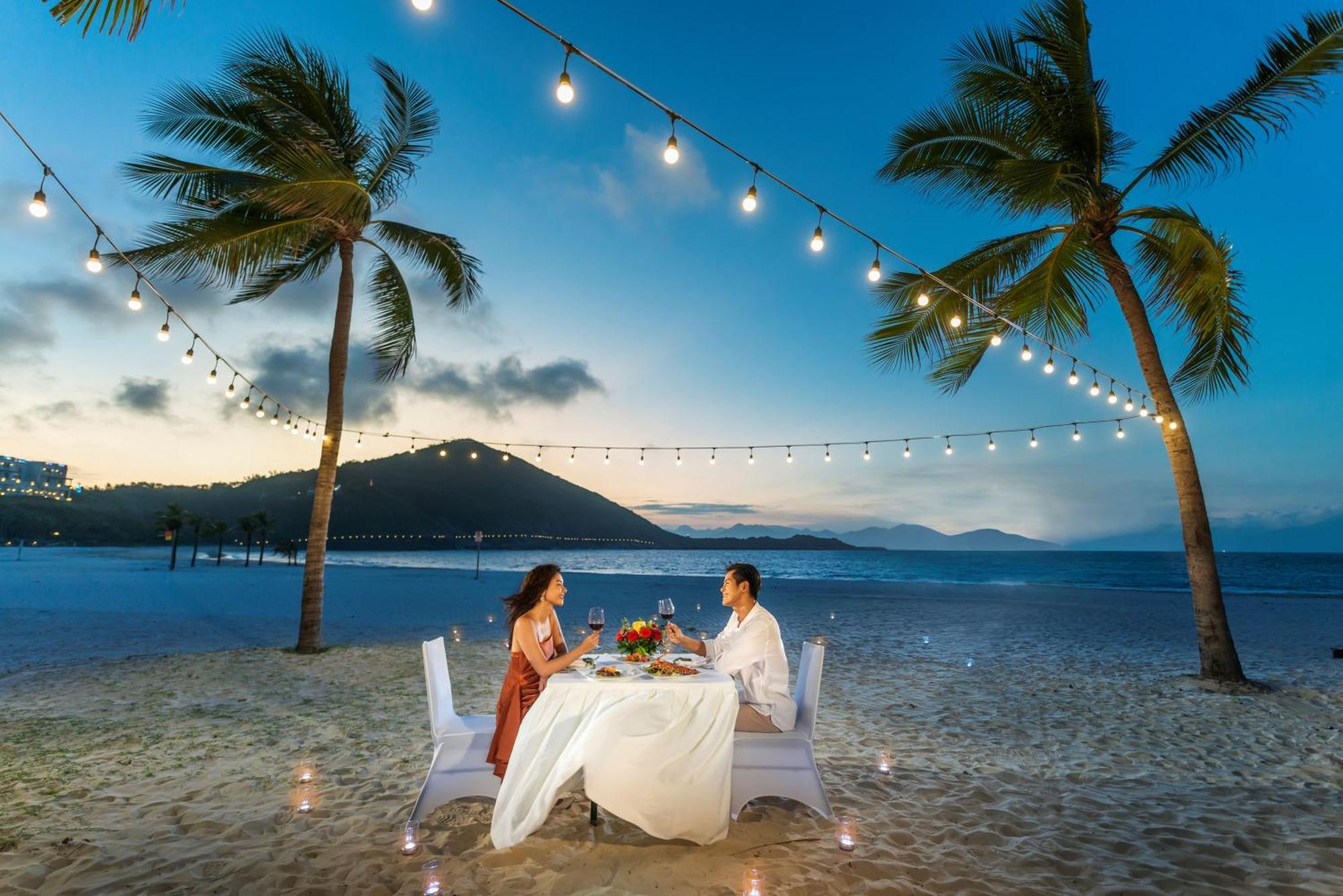 Vinpearl Resort & Spa Nha Trang Bay Exteriör bild A couple dining on a beach at the resort